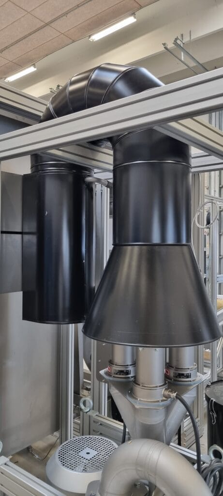 Industrimaskine med sorte rør og ventilationssystem